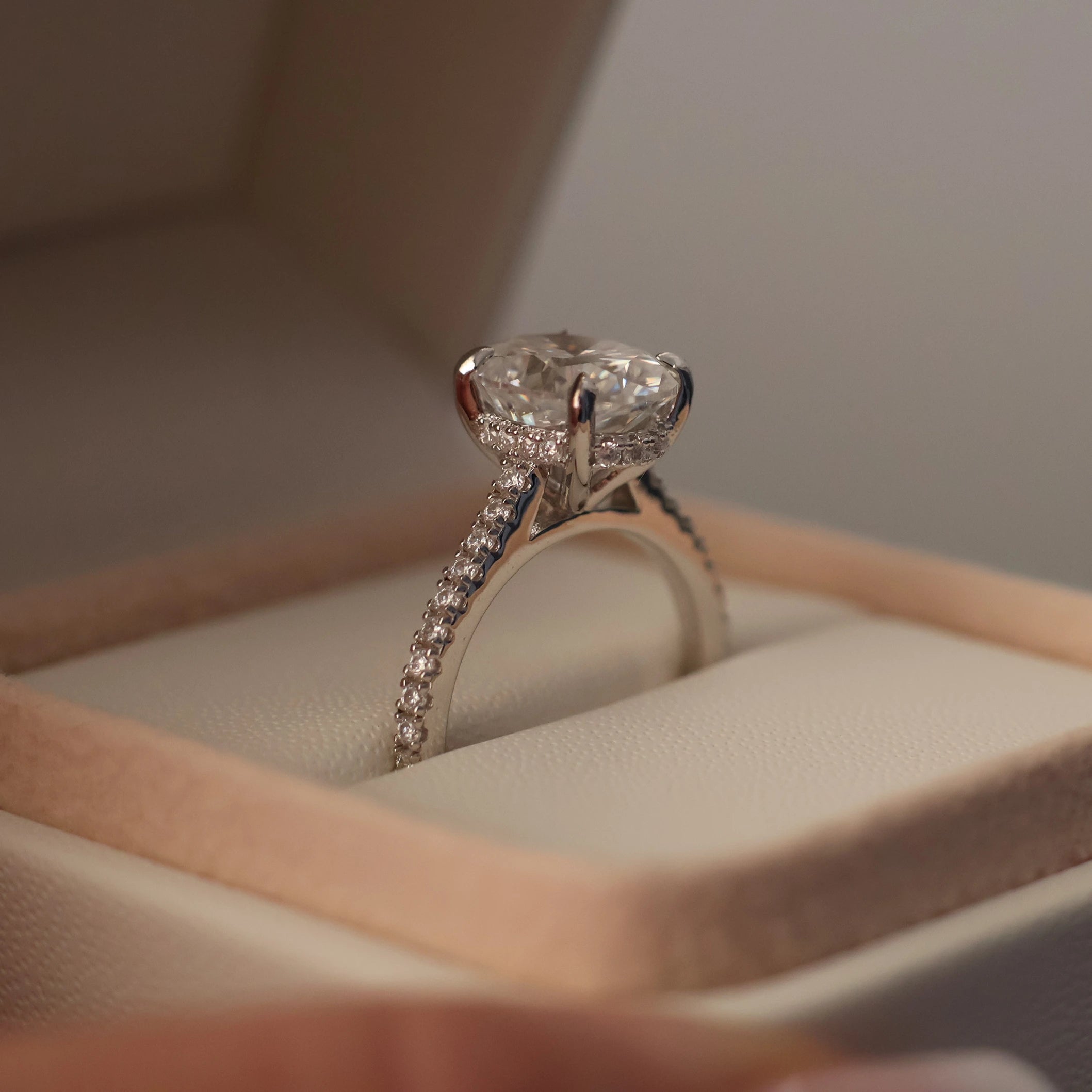 3 carat oval moissanite ring with a silver pave band