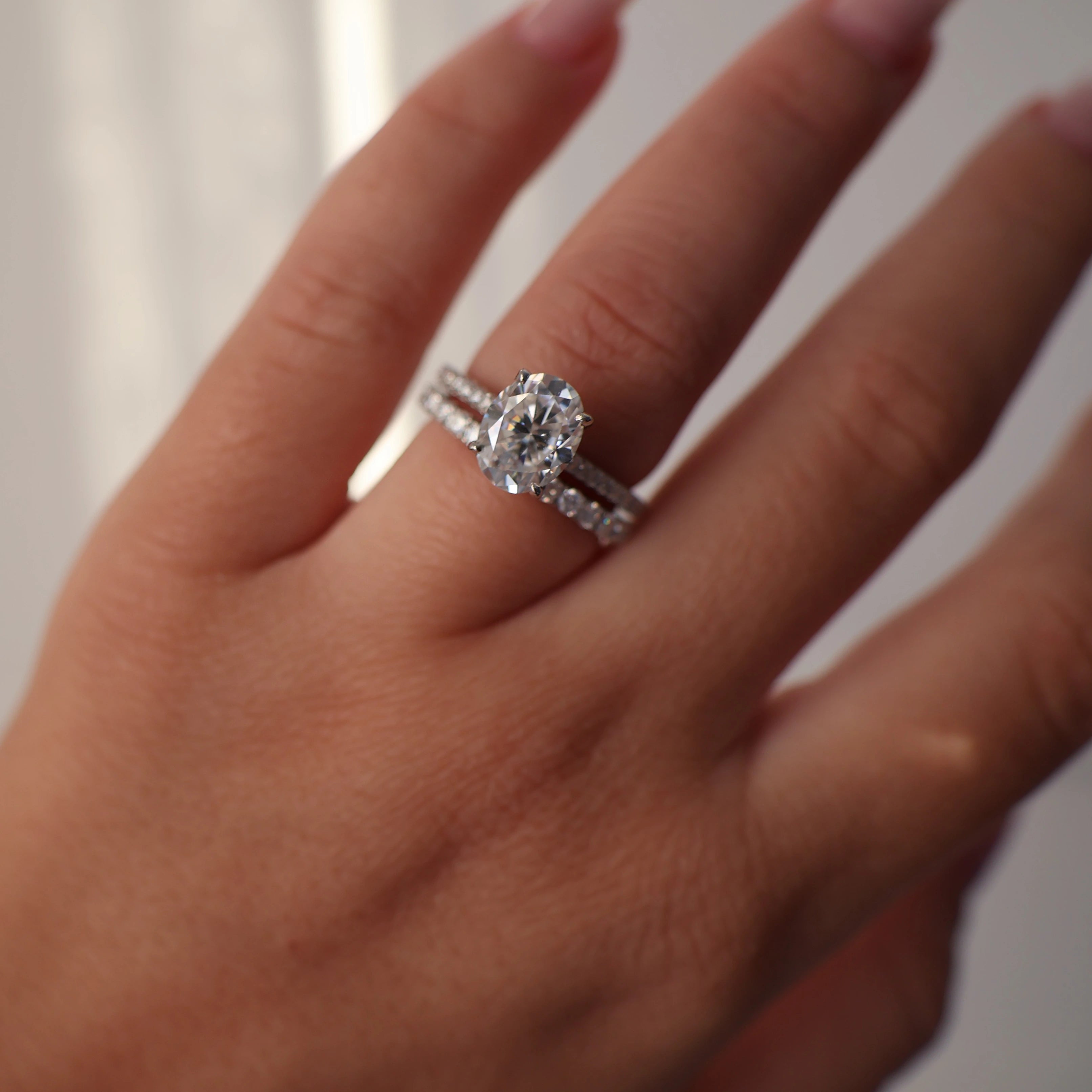 Oval moissanite engagement ring with silver pave band and 2 carat centre stone