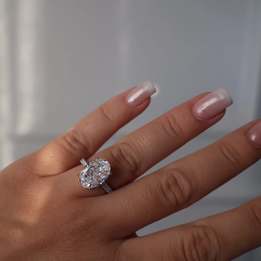 oval cut 4 ct silver ring featuring pavé band