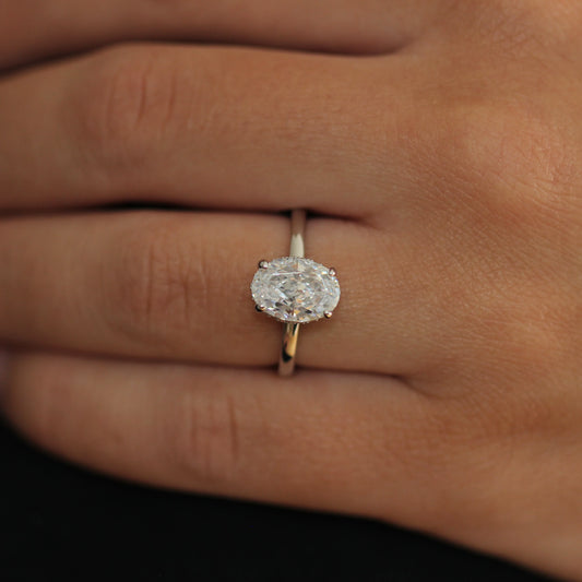 2 carat silver oval ring on finger with hidden halo setting