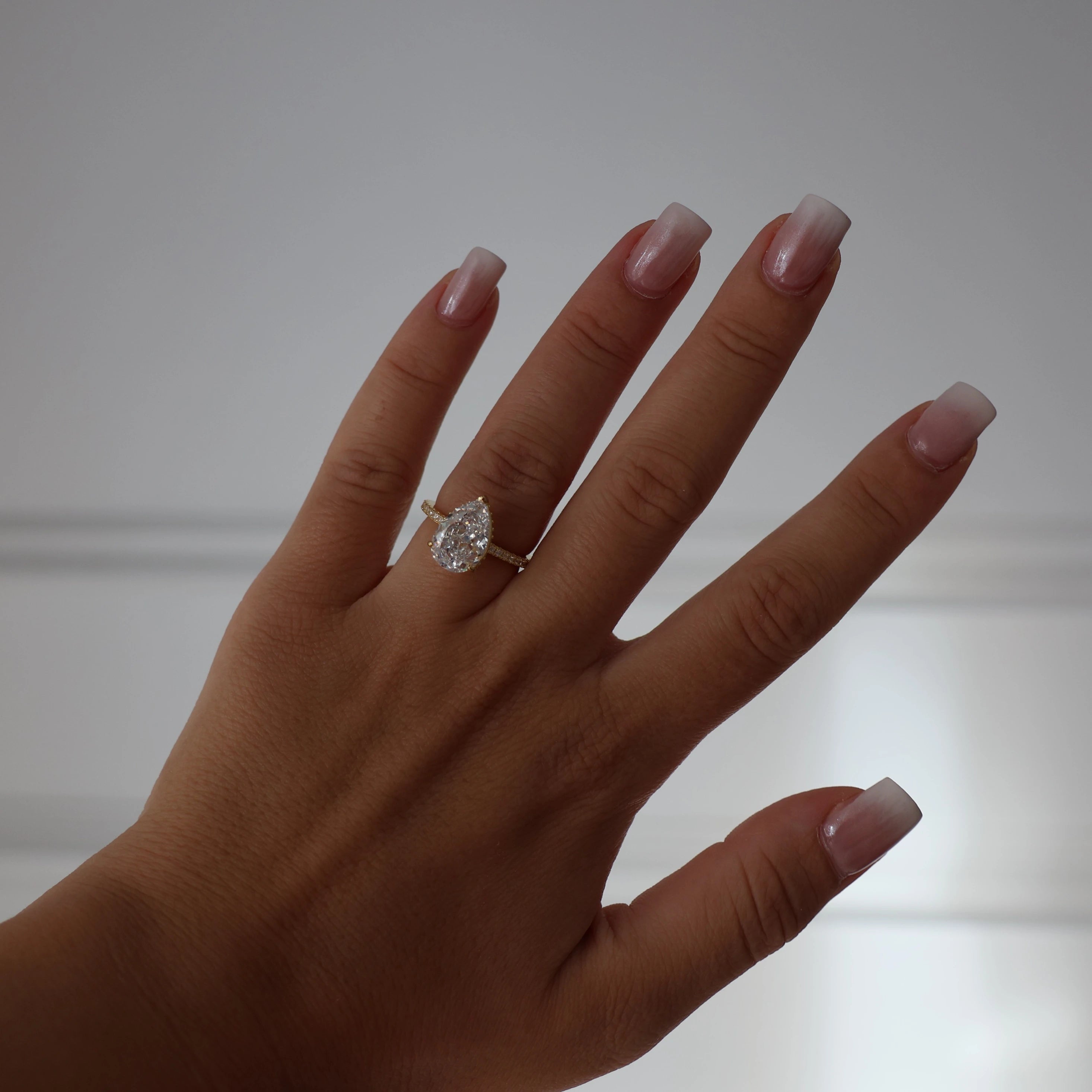 Gold pavé pear cubic zirconia ring with 3 carat center stone