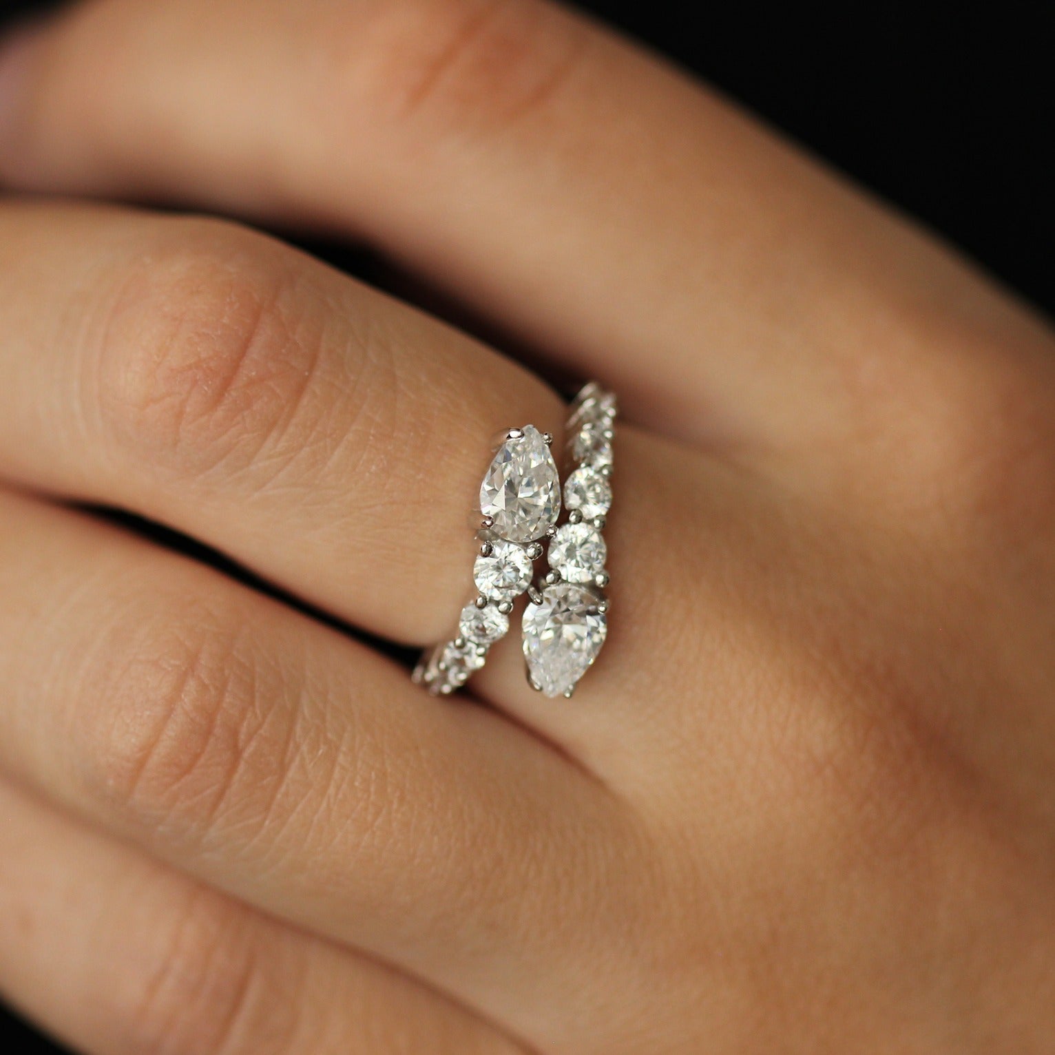 cubic zirconia ring with pear overlapping design on hand