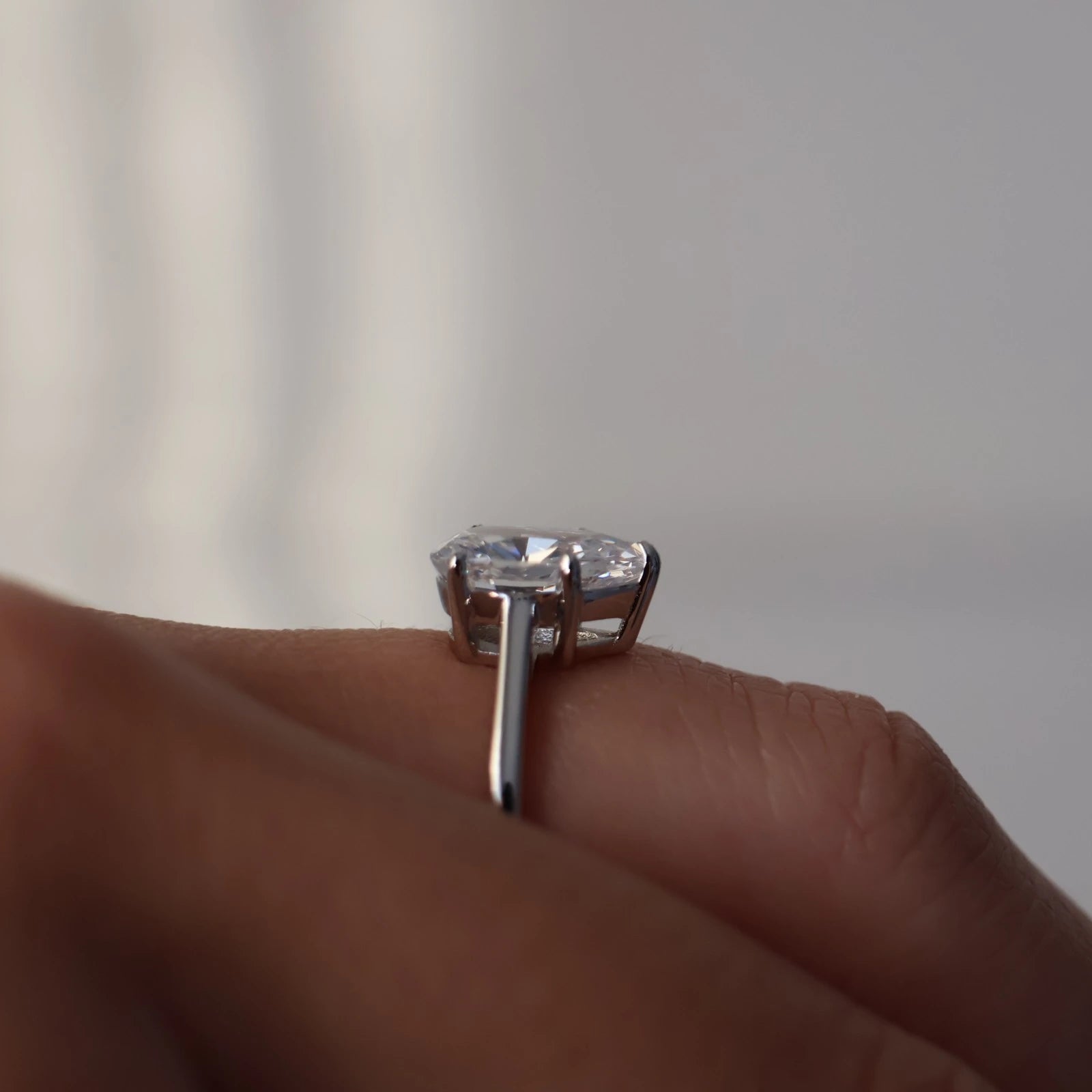 side profile of 1.75 carat pear shaped silver solitaire ring