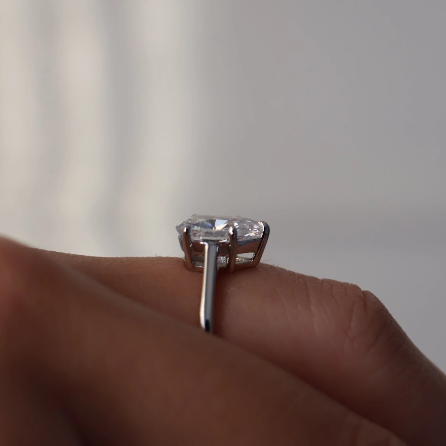 side profile of 1.75 carat pear shaped silver solitaire ring