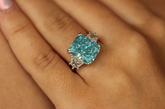 radiant blue stone ring 6 carat on hand