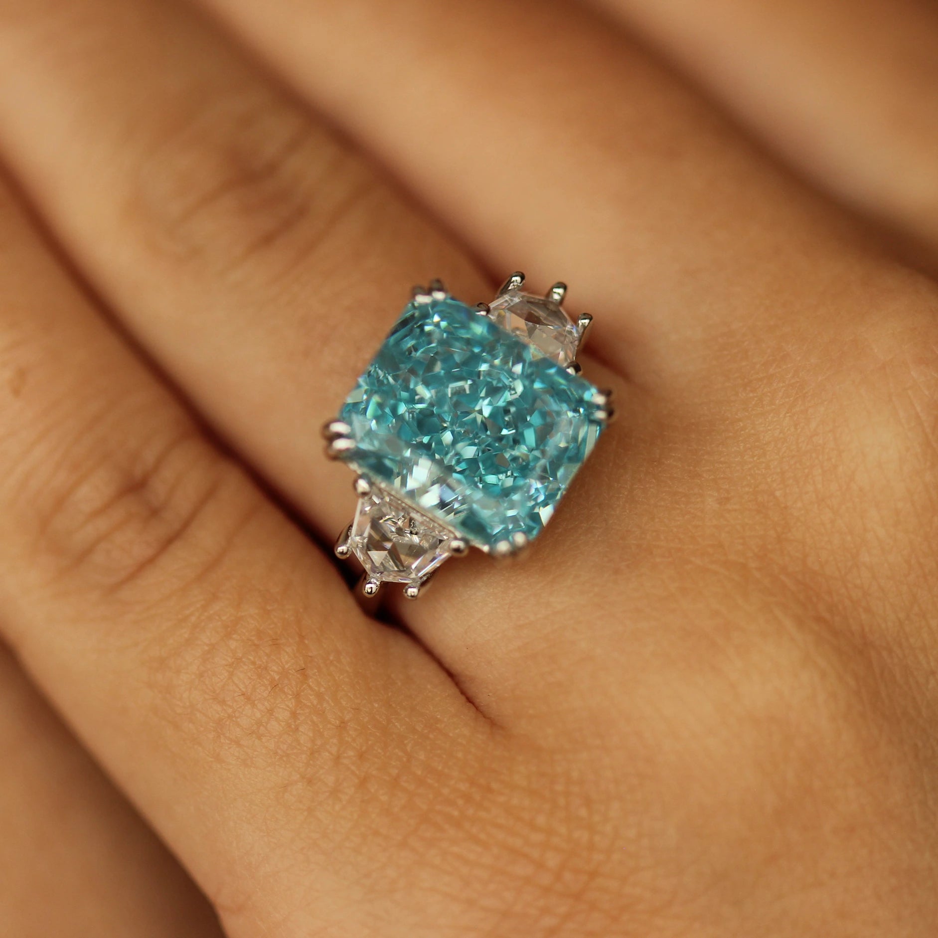 radiant blue stone ring 6 carat on hand