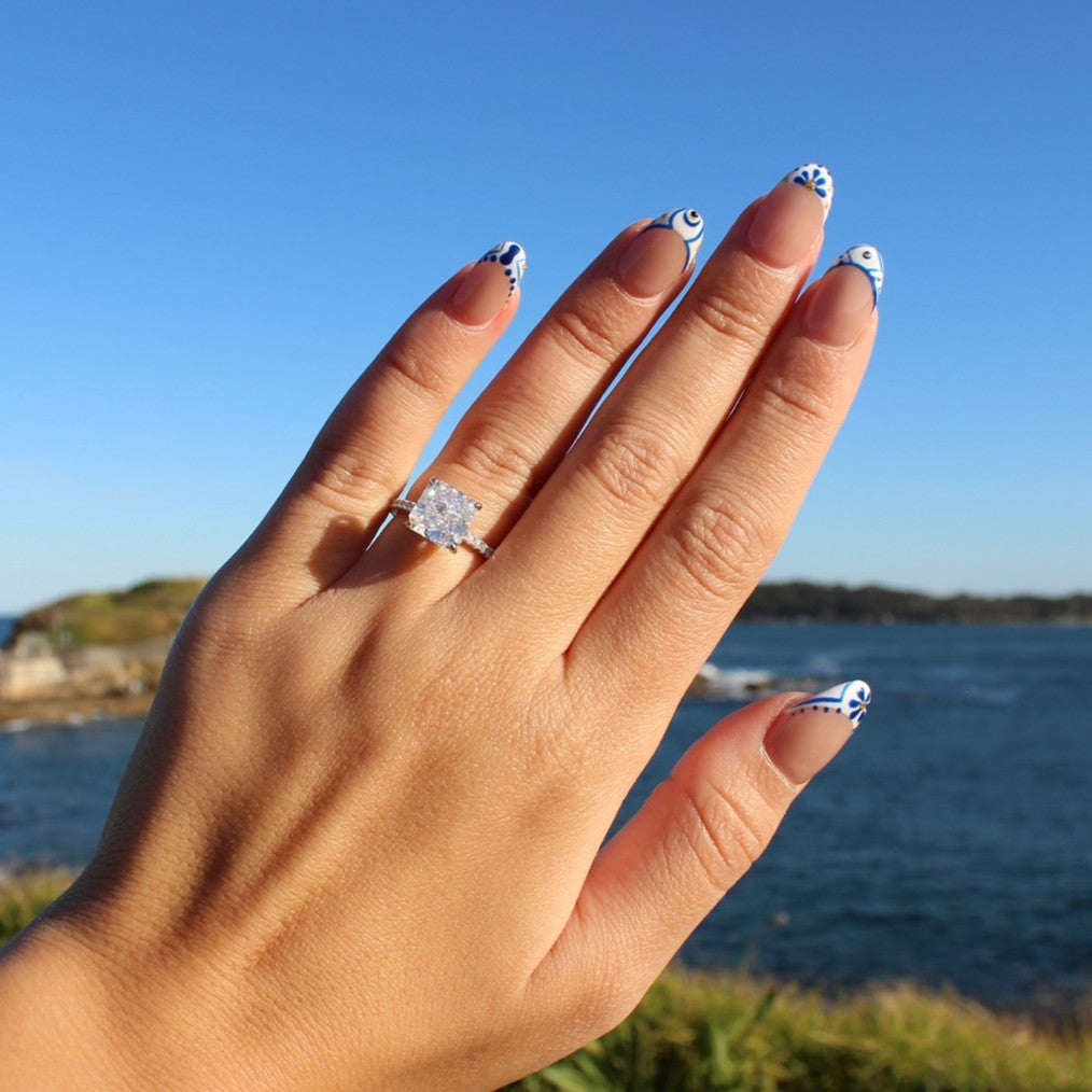 Silver radiant cut ring on hand at La Perouse Beach Sydney