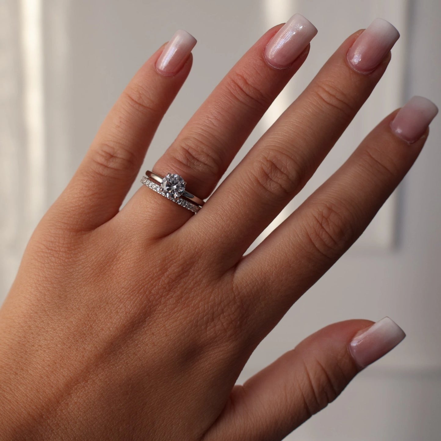 Round 1 ct silver ring paired with a stacked eternity band