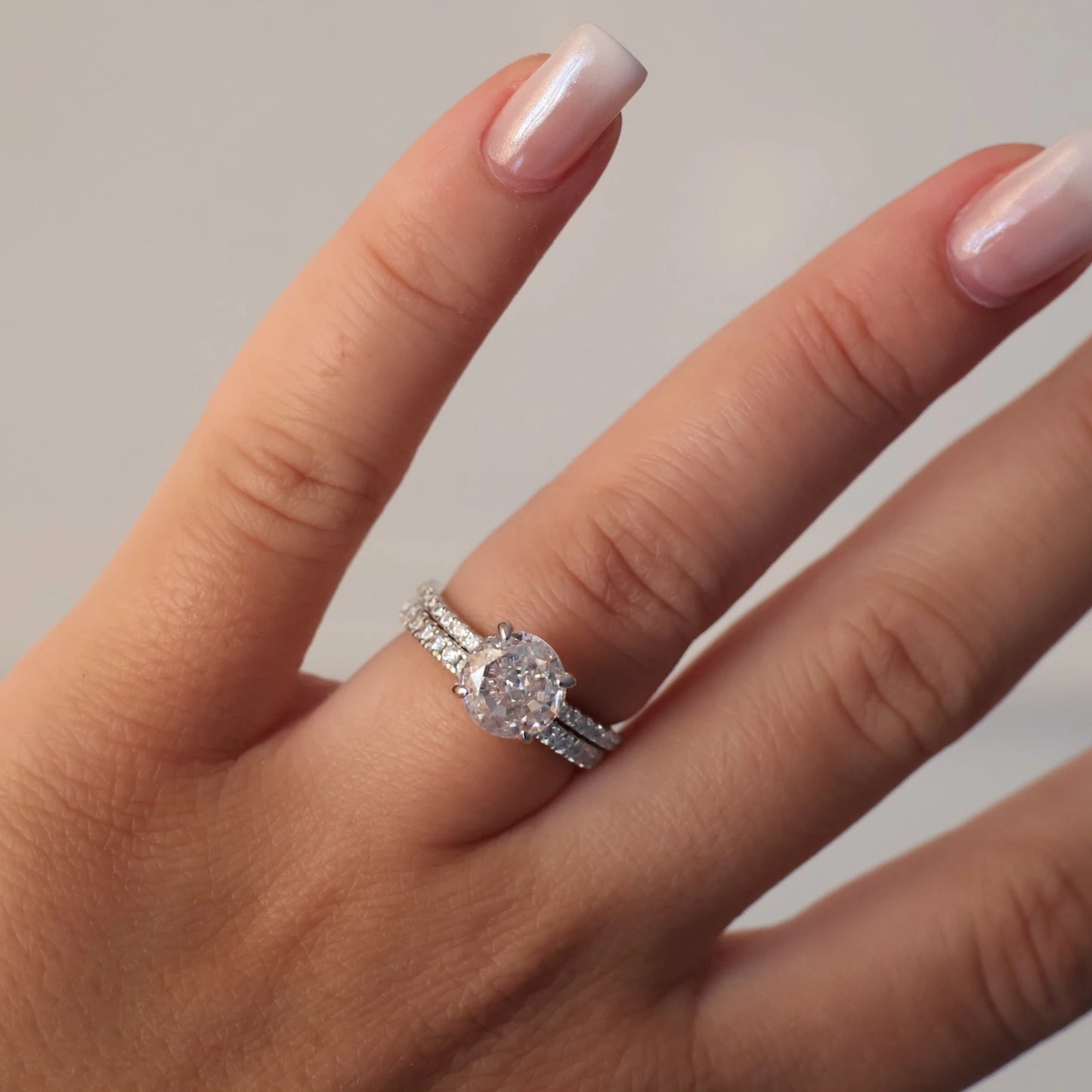 2 carat round cut ring stacked with silver eternity band