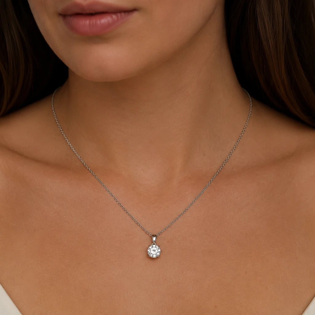 Close up of round cut lab diamond pendant on model