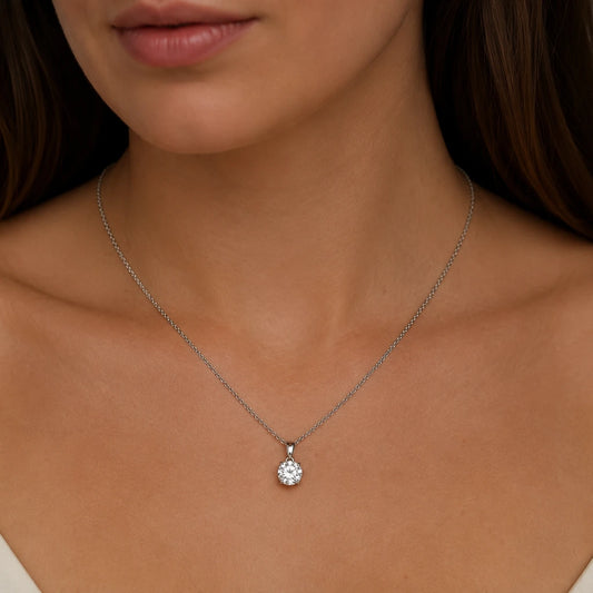 Close up of round cut lab diamond pendant on model