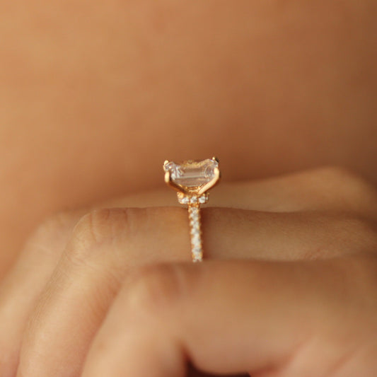 emerald cut gold ring with 2 carat cz stone  on hand side halo