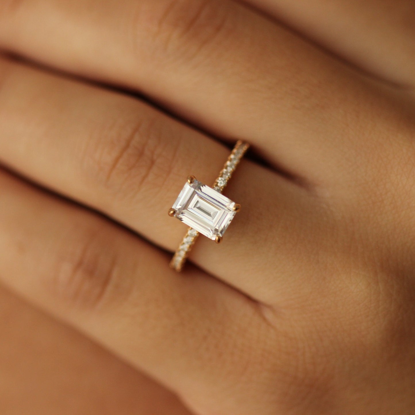 emerald cut gold ring with 2 carat cz stone  on hand