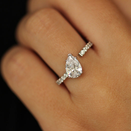 silver adjustable ring with pear stone that is tilted on an angle