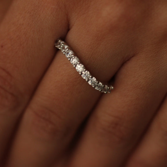 Silver curved stacker ring on hand