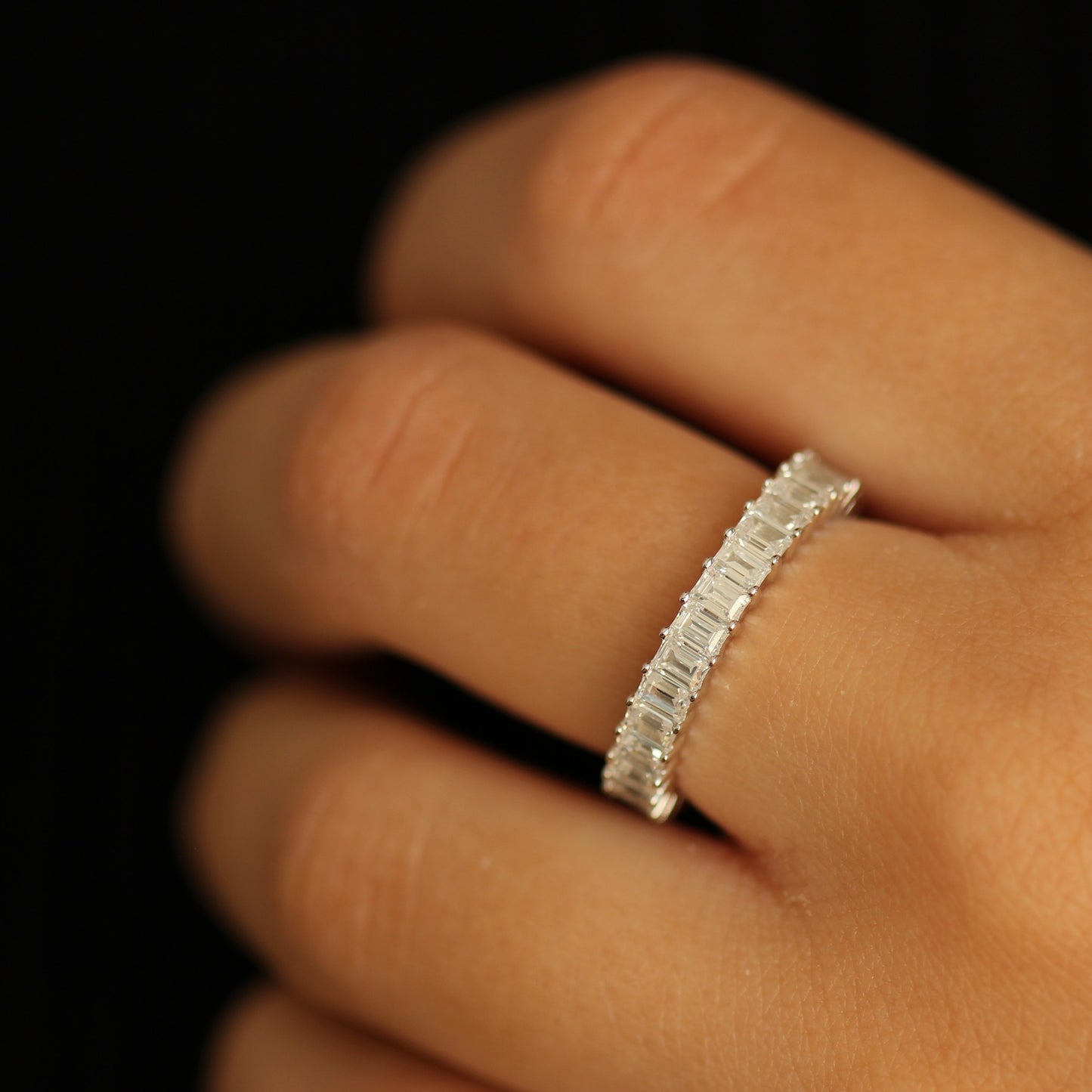 silver 3mm cubic zirconia emerald eternity band on hand