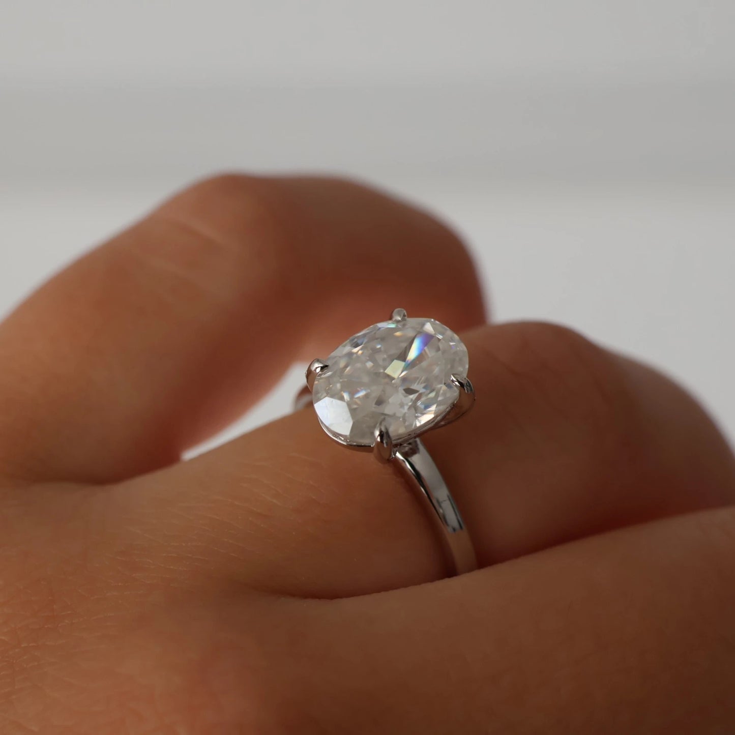 Silver oval moissanite engagement ring featuring a 4ct crushed ice stone