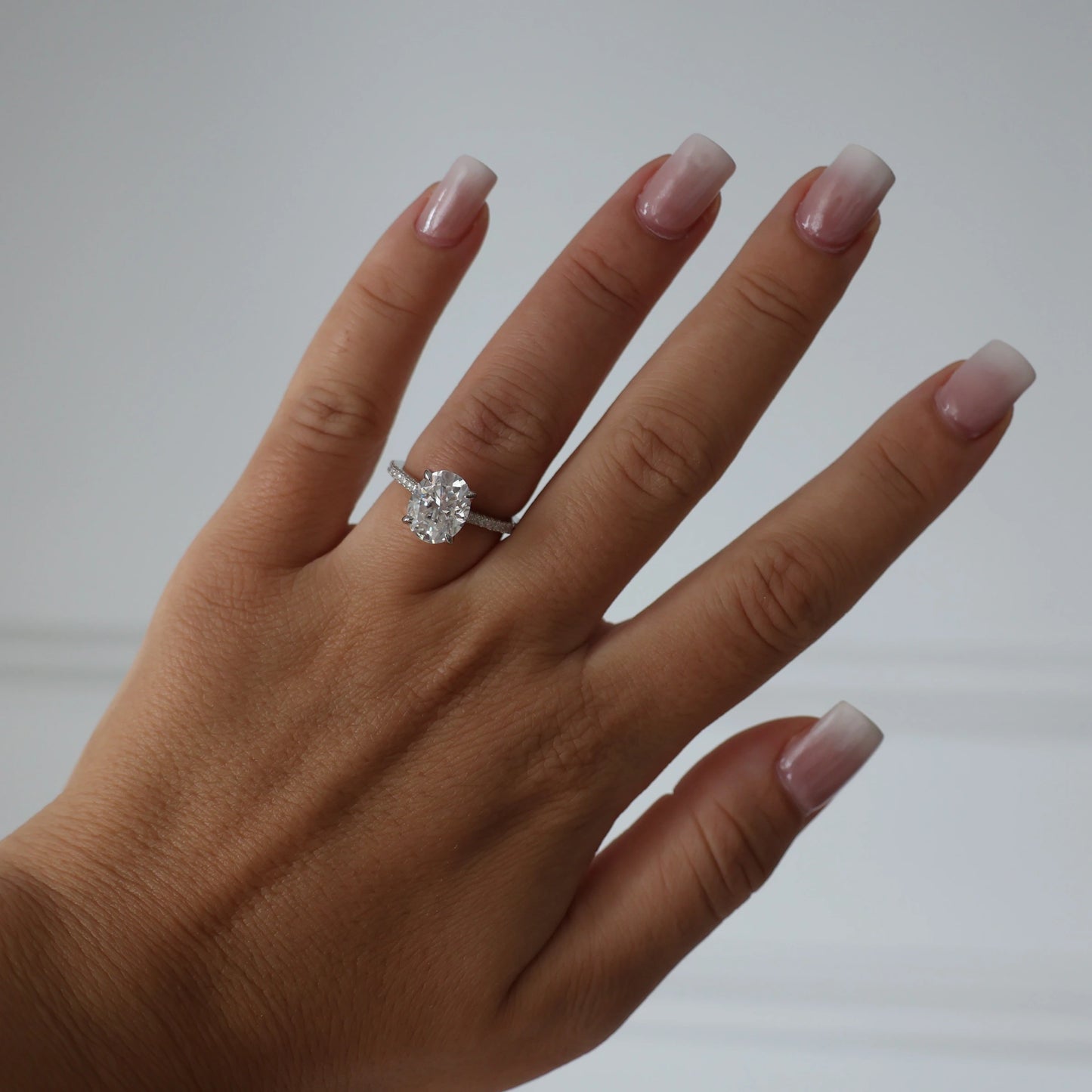 silver oval cut 3 ct moissanite ring featuring hidden halo