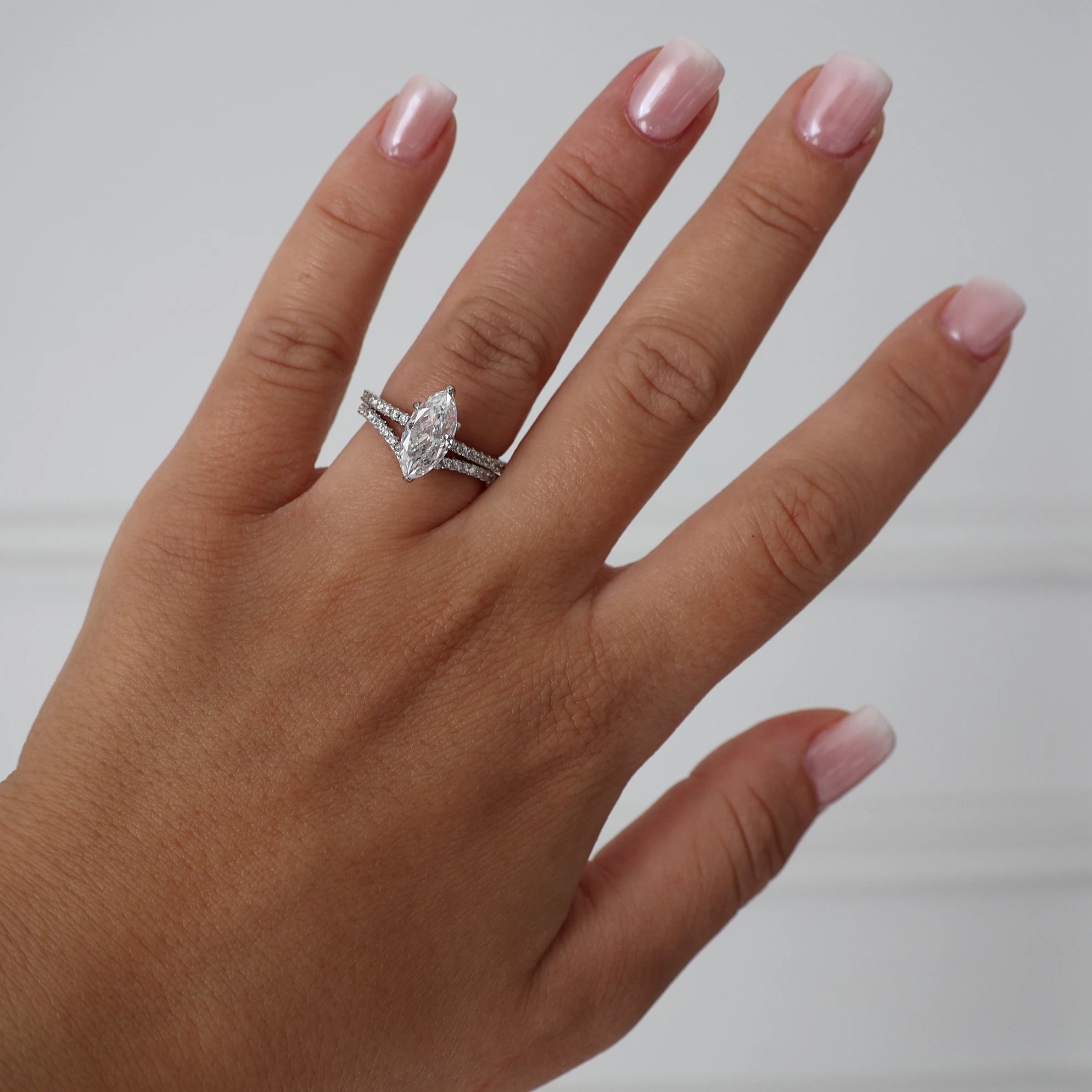 Silver wishbone ring stacked with a marquise cut cubic zirconia engagement ring