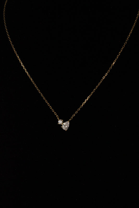Toi et Moi Necklace Pear and Round Pendant Design on black background