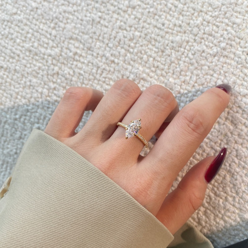 marquise ring in champagne gold on a females hand with red nails