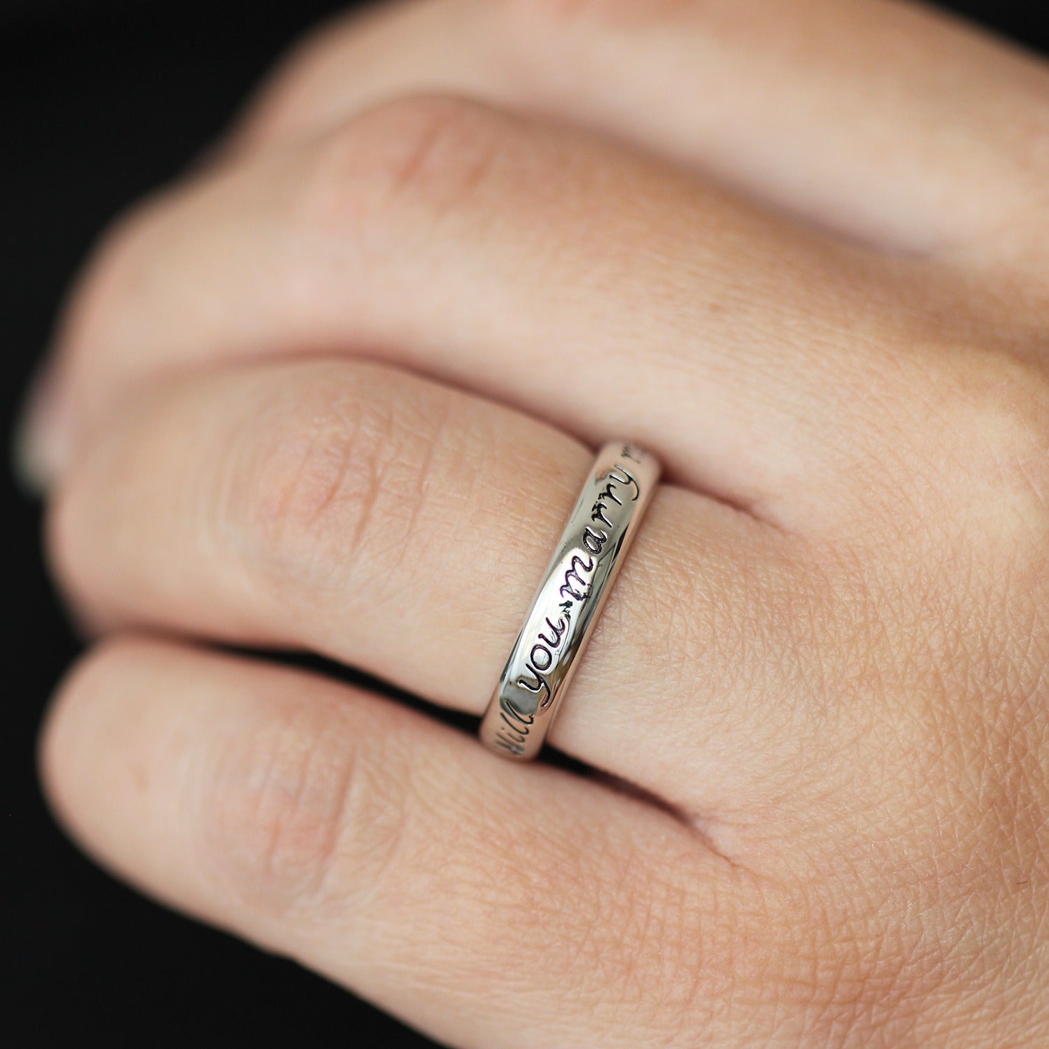 silver proposal ring with will you marry me engraved on it